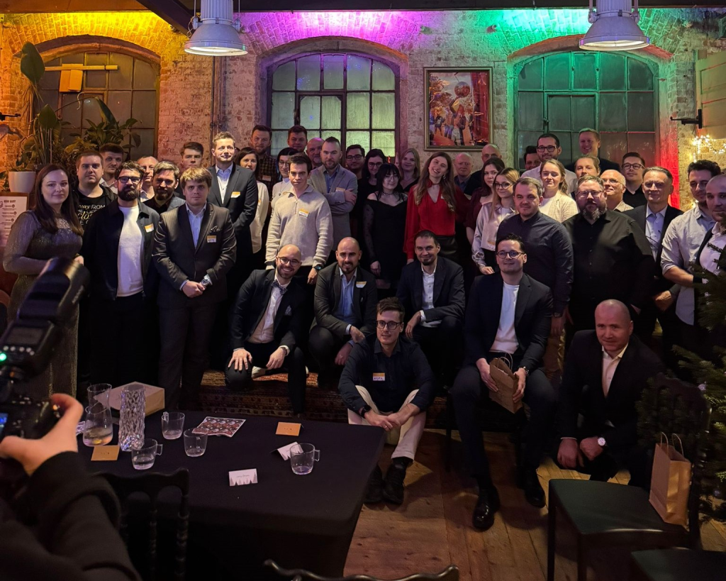 VM.PL employees gathered for a group photo during the company's Christmas party in a festively decorated venue, celebrating the holiday season in a warm and friendly atmosphere.