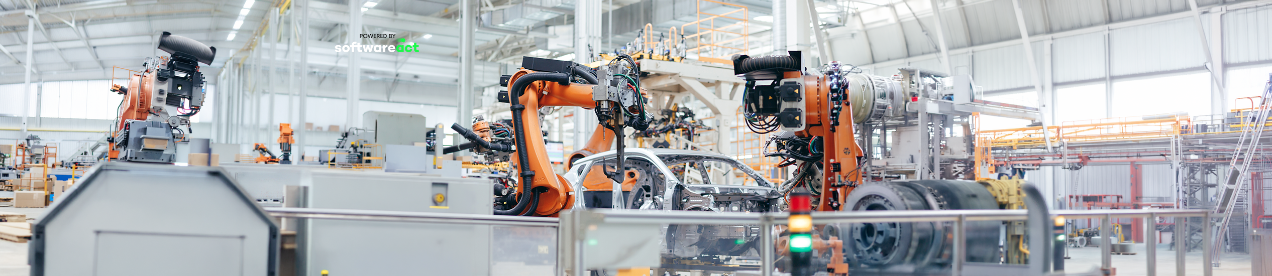 Automated automotive production line with industrial robots working around a car body in a modern manufacturing facility.